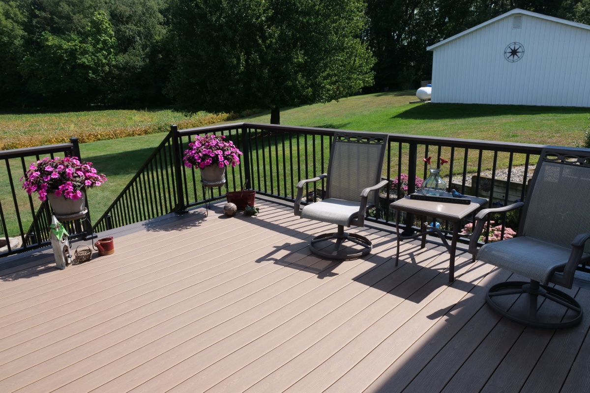 Spacious composite deck with black aluminum railing and outdoor furniture, Northern Indiana